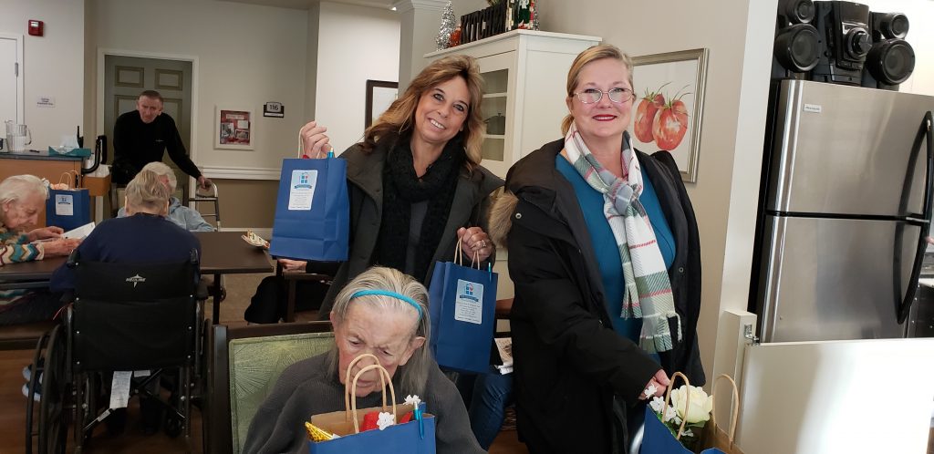 Toni and Karin delivering holiday bags to memory care facility